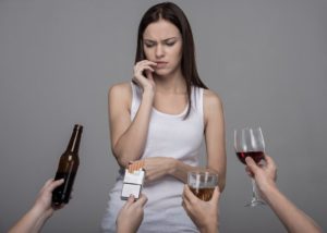Portrait of a young woman who refuses to alcohol and tobacco. Young girl struggling with her bad habits.